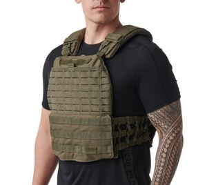 Best Weighted Vests, December 2021 Man with tatoo on his left arm, wearing a black shirt and a dark green weighted vest.