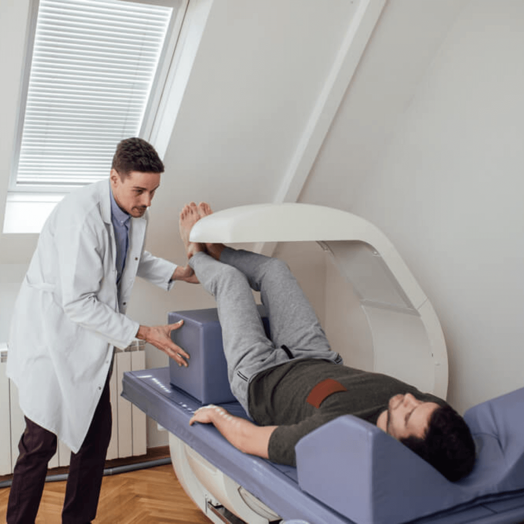 What is the Best Way to Measure Body Fat, December 2021 A doctor assisting a patient to use DEXA Scan